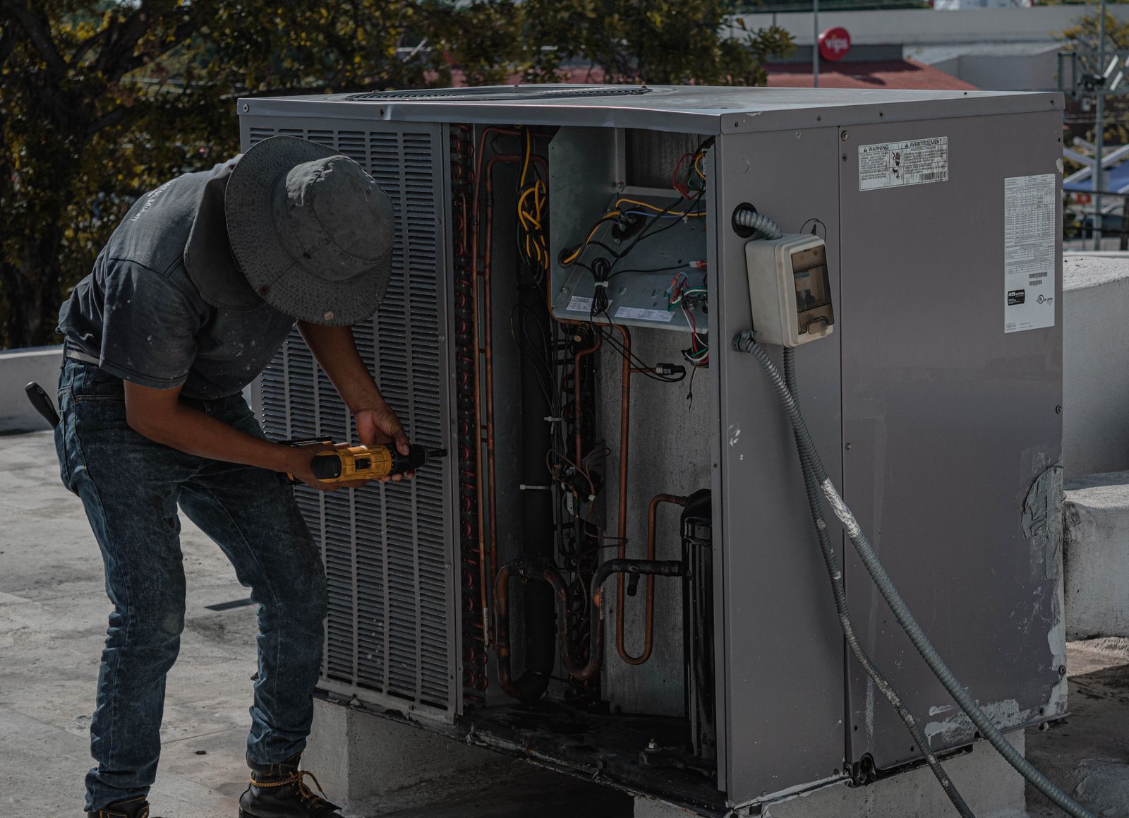 Technician servicing a rooftop HVAC unit