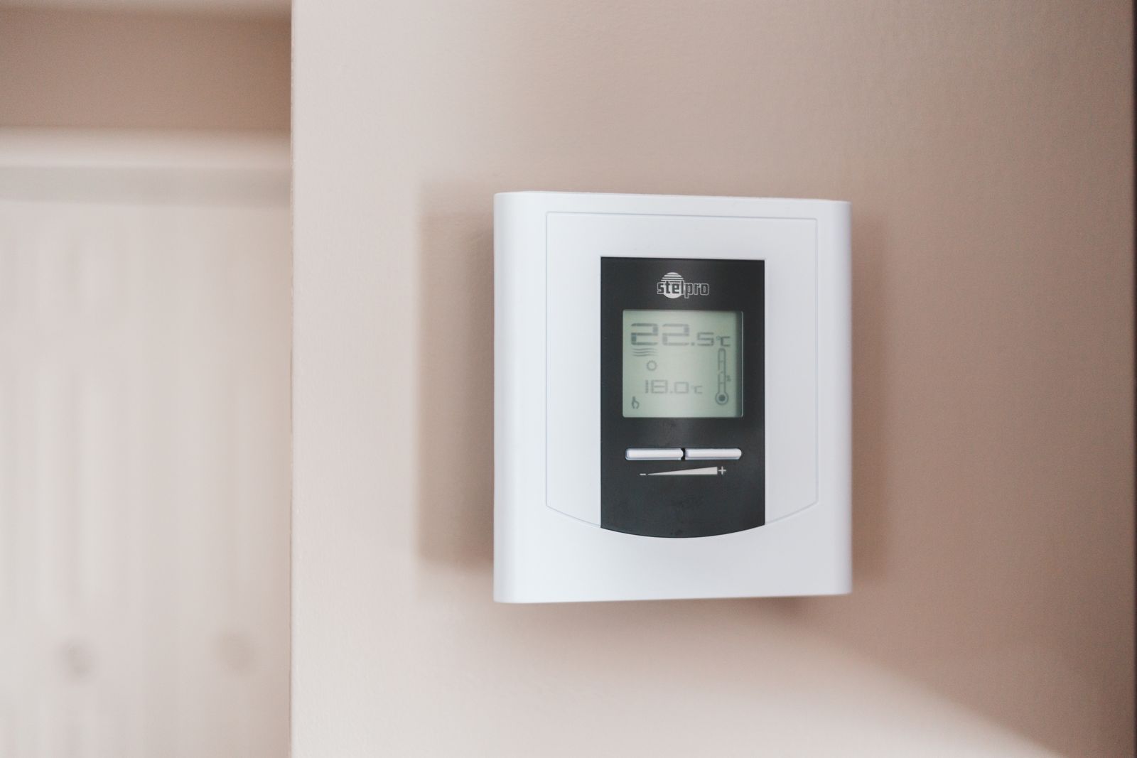 Thermostat mounted on a home wall